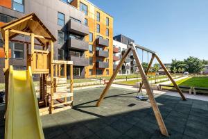 a playground with a slide and a swing set at W Apartments Uus-Hollandi with sauna in Tallinn