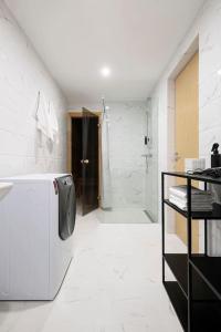 a white bathroom with a shower and a refrigerator at W Apartments Uus-Hollandi with sauna in Tallinn