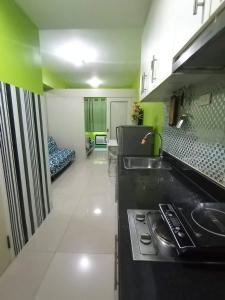 a kitchen with a sink and a stove at SEA RESIDENCES Yeshua in Manila