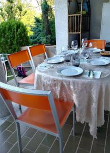 einen Tisch mit Tellern und Weingläsern darauf in der Unterkunft La Finestra sul Lago in Brusimpiano