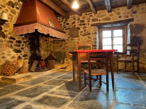 a kitchen with a table and a stove at OIHARTE in Cerain