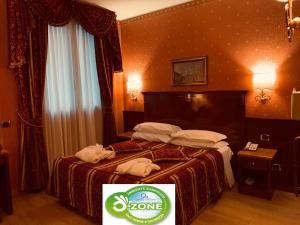 Postel nebo postele na pokoji v ubytování Hotel Vittoria