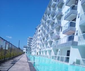 a building with a swimming pool in front of it at Marda Room By Vivo Apartment in Yogyakarta