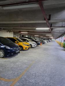 a group of cars parked in a parking garage at Marda Room By Vivo Apartment in Yogyakarta