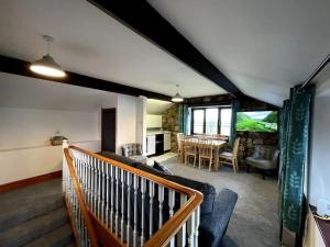 een woonkamer met een bank en een tafel bij Rhossili's Retreat - AONB - Gower Rural Sleeps up to 6 in Swansea