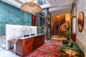 a lobby with a couch and a chandelier at Boutique Hotel Cordial Plaza Mayor de Santa Ana in Las Palmas de Gran Canaria