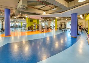 a gym with blue columns and a fitness floor at HOMESTAR, Jumeirah Beach Hostel - JBR - Pool, Beach, Metro in Dubai