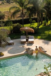 a woman in a swimming pool in a resort at Tenuta Negroamaro in Gallipoli