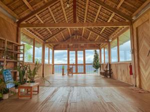 a large room with a large wooden ceiling with windows at Nẫu Ecovalley 