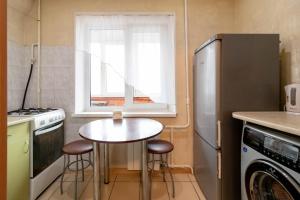 a small kitchen with a table and a window at Kvartirkoff na Geroev Dnepra 3 in Kyiv
