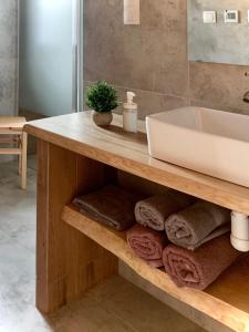 a bathroom with a sink and a counter with towels at Domki Na Szlaku in Milówka