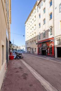 an empty street in a city with tall buildings at Vieux Port : Le Pavillon in Marseille