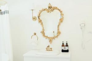 a bathroom with a mirror and a sink at La Villa de Adelina in Ensenada +62 photos