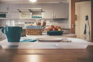 a kitchen with a table with a bowl of fruit at Oportocean Hostel in Matosinhos