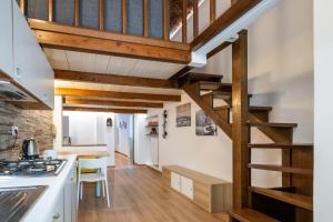 a kitchen and dining room with wooden beams at CasaCasalis - Immersi nella Torino Liberty in Turin