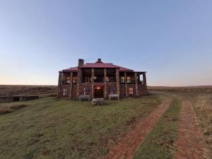 an old house in the middle of a field at Stone Castle, Dullstroom Country Estate in Dullstroom