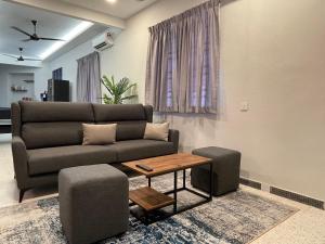 a living room with a couch and a table at -NEW- 16Px V Kids Pool n KTV n Jacuzzi n Billiard near USM n Penang Bridge in George Town