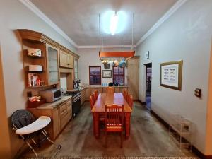 a kitchen with a wooden table and chairs and a kitchen with a stove at Stone Castle, Dullstroom Country Estate in Dullstroom