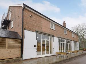 a brick building with a bench in front of it at Harbour View - Ukc2303 in Wainfleet All Saints