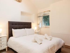 a bedroom with a large white bed with two pillows at Beach Road House in Ilfracombe