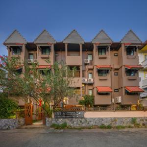 a large apartment building with a sign in front of it at Estia Chiangmai -SHA Plus in Chiang Mai