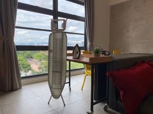 Schlafzimmer mit einem Schreibtisch und einem Bett mit einem großen Fenster in der Unterkunft 2R1B 5Pax Union Executive Suites Bandar Sunway in Petaling Jaya