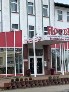 a hotel with a sign in front of a building at Hotel Bitterfelder Hof - Mongoo GmbH in Bitterfeld