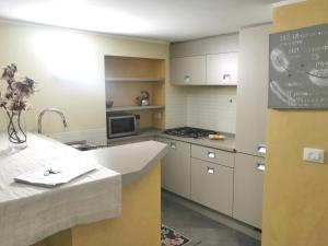a kitchen with white cabinets and a sink at TORINO VACANCY 4 - Bridge House in Turin +14 photos