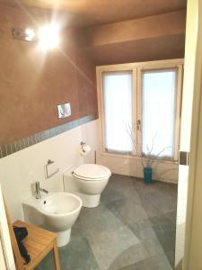 a bathroom with a toilet and a sink at TORINO VACANCY 4 - Bridge House in Turin