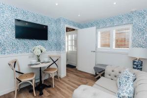 a living room with a couch and a table at Stable Mews, Prestbury Cheltenham in Southam