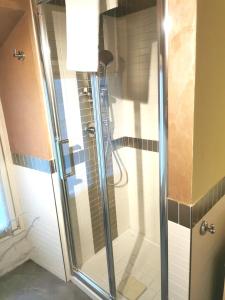 a shower with a glass door in a bathroom at TORINO VACANCY 4 - Bridge House in Turin