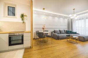a living room with a couch and a table at Bianca Apartment with free parking in Novi Sad
