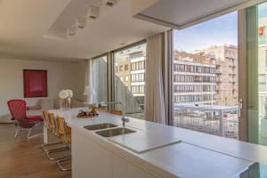 a kitchen with a sink and a large window at Prachtig & ruim luxe appartement in Bruges