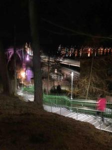 a person standing on a bench at night at Viehättävä asunto Heinolan keskustassa in Heinola +3 photos