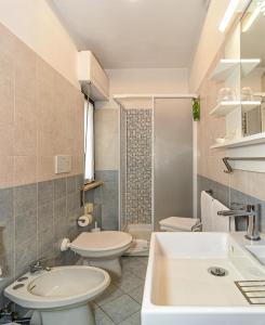 a bathroom with a toilet and a sink at Hotel Paris in Lido di Camaiore