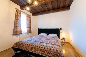 a bedroom with a bed and a window at Ranč pod Ostrou Skalou in Stratená