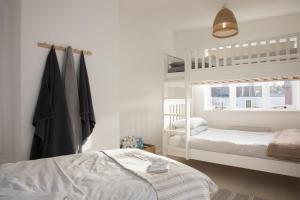 a bedroom with two bunk beds and a window at Apartment Two at the Courtyard, Number 11 in Audlem