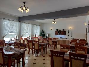 a dining room with wooden tables and chairs at D.W. Harnaś in Białka Tatrzańska