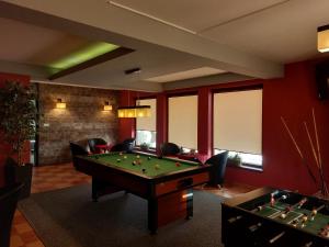 a billiard room with a pool table and chairs at D.W. Harnaś in Białka Tatrzańska