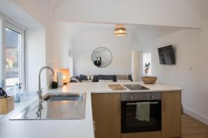 a kitchen with a sink and a counter top at Apartment Two at the Courtyard, Number 11 in Audlem