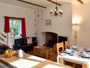 a living room with a table and a dining room at The Mews - Ukc4125 in Bridgerule