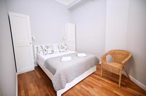 ソポトにあるSalsa Sopot Apartmentの小さなベッドルーム(ベッド1台、椅子付)