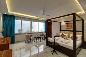 a bedroom with a bed and a living room at Antalya Villa - 5BHK with Private Pool, Baga in Baga