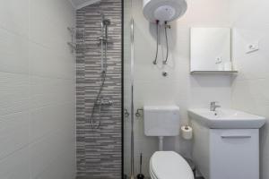 a bathroom with a toilet and a sink and a shower at Apartment Barica in Trsteno