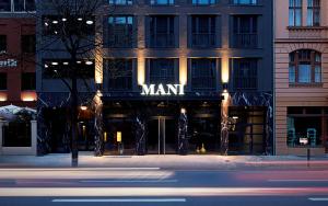 a building with a man sign on the front of it at Hotel MANI by AMANO in Berlin