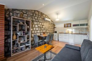 a living room with a couch and a table at Apartment Barica in Trsteno