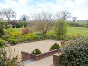 a garden with a stone circle in the middle at Barnex in Clippesby
