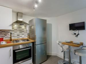 a kitchen with a stainless steel refrigerator and a counter at Fishermans Rest in Broadstairs