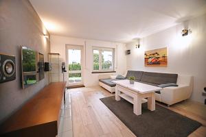 sala de estar con sofá y mesa en Victus Apartamenty, Apartament Sopot, en Sopot