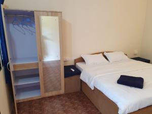 a small bedroom with a bed and a mirror at Saxony Village Resort in Agonda